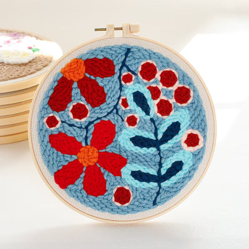 Red Blooms Branch Punch Needle Kit - red and orange floral design with light blue leaves on a denim blue background