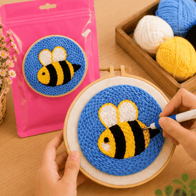 Punch needle embroidery kit with a bumblebee design on a blue background