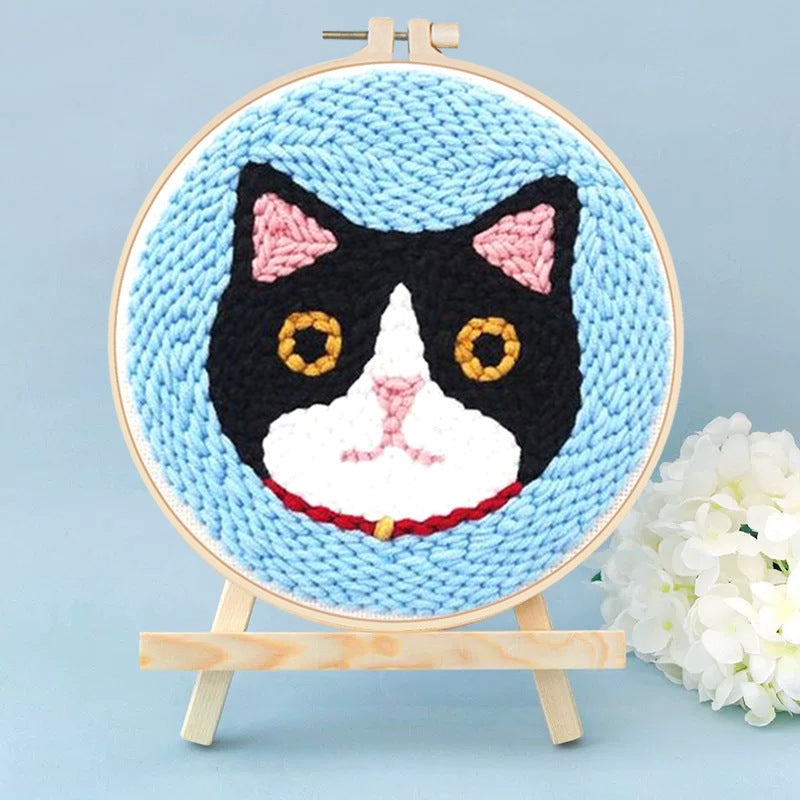 Tuxedo Cat Portrait Punch Needle Kit - black and white tuxedo cat design on a light blue background
